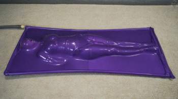 Vacuum Dreams - Purple vacuum bed with rope bondage and vibro belt.webp