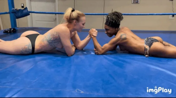 Protein Wrestling - Part 1 Jolene Hexx vs Kirra Blaze in a topless competitive arm wrestling match.webp